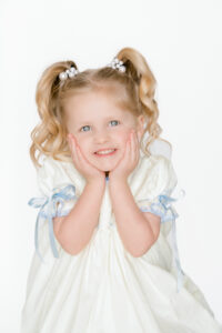 Baton Rouge baby boutique styled a blonde haired girl with pigtails.