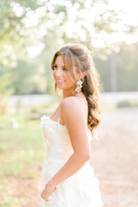 A gorgeous bride-to-be in a long white dress with appliques.