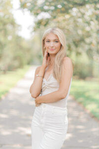 A beautiful blonde senior wearing neutral colored clothing purchased from boutiques in greater Baton Rouge.