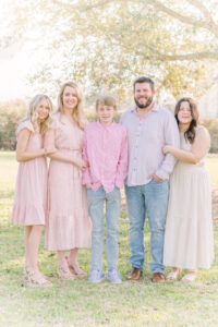 A family of five perfectly poses for a family session by Morgan Sandifer with Morgan Leigh Photography.