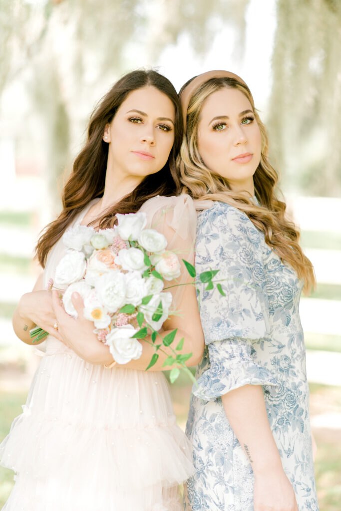 Sisters pose seriously as they model two dresses for a client closet for Morgan Leigh Photography in Baton Rouge