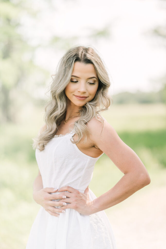 A Baton Rouge senior looks down at her left shoulder as she poses during a summer session.