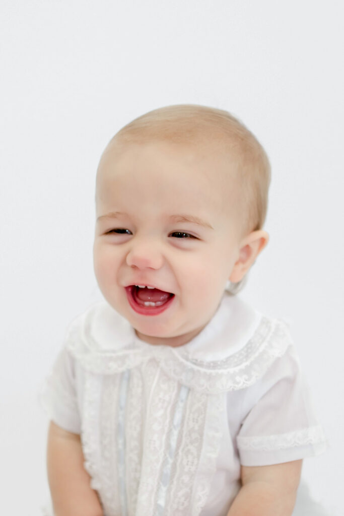 Young boy smiles during heirloom session with Morgan Leigh Photography.