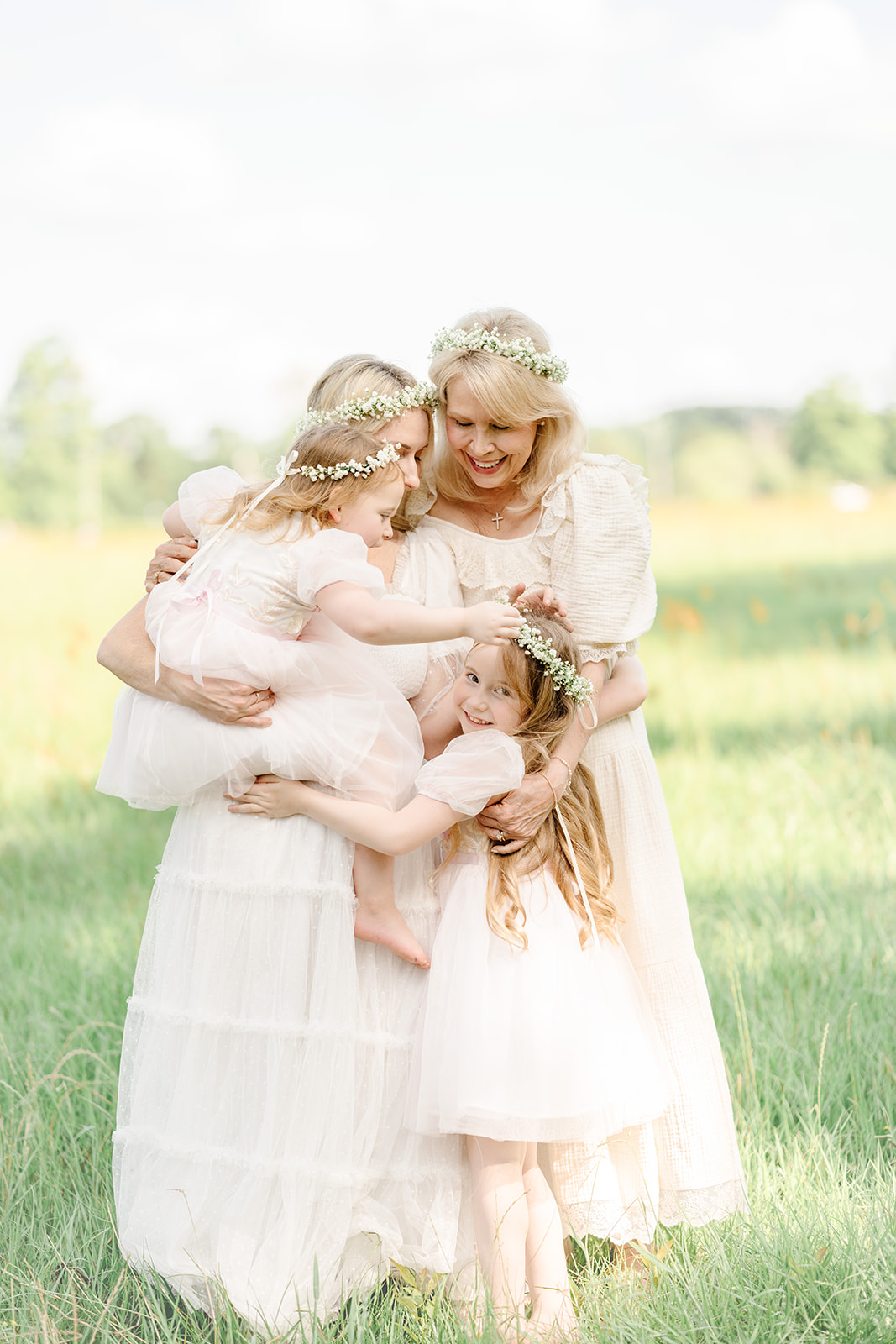 Group hug with mom, grandma, and granddaughters for a photo session with Morgan Leigh Photography.